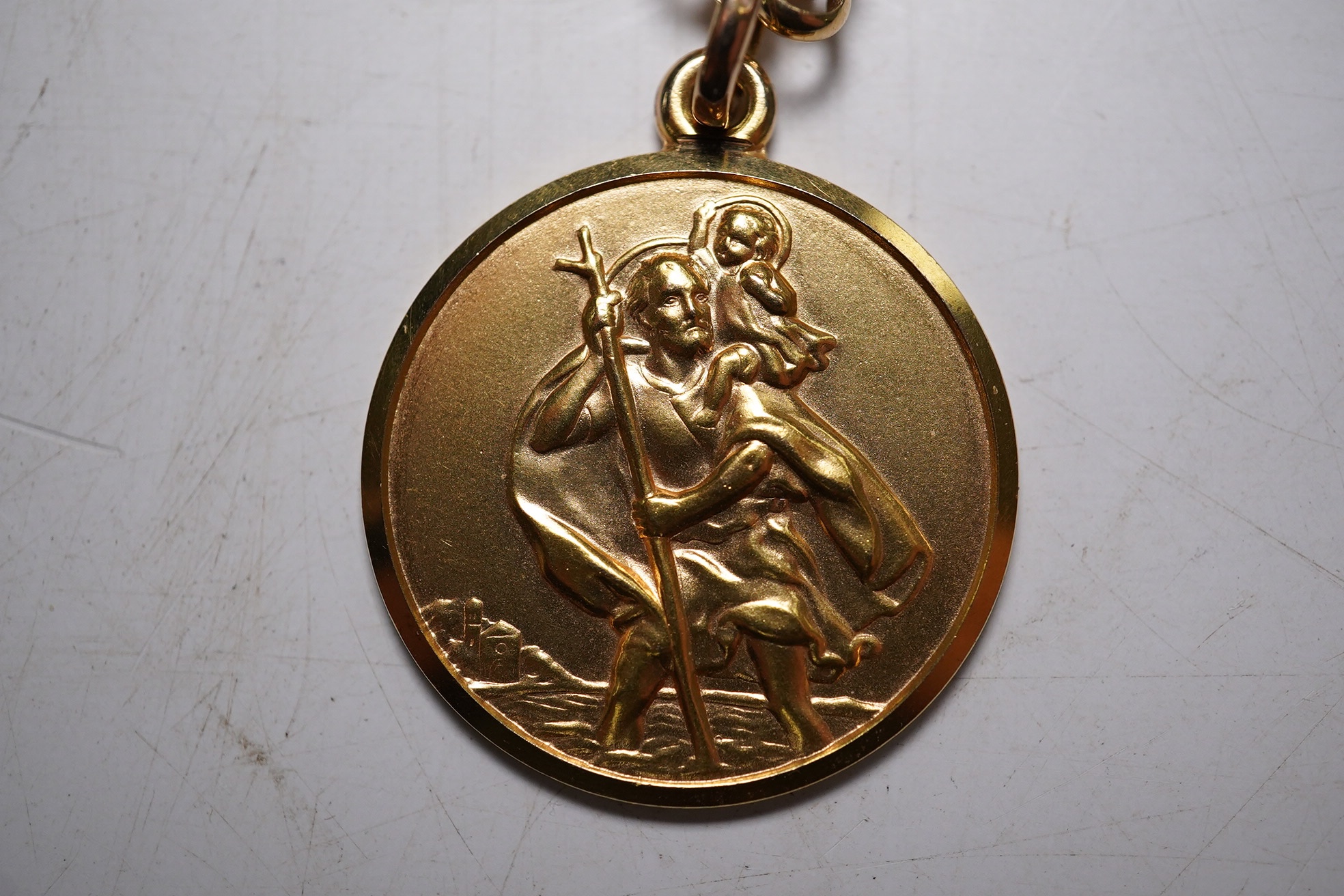 A modern Italian Uno-A-Erre 9k Saint Christopher pendant, on a 9ct gold chain (chain clasp a.f.), 23.5 grams. Condition - poor and good.